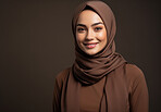 Studio portrait of happy muslim woman against backdrop. Religion concept.