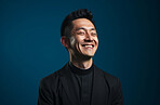 Side portrait of asian priest smiling eyes closed. Against backdrop. Religion concept.