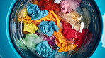 Colorful clothes in washing machine. Clean clothes housekeeping concept