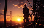 Silhouette of engineer on a construction site at sunset. Golden hour concept.