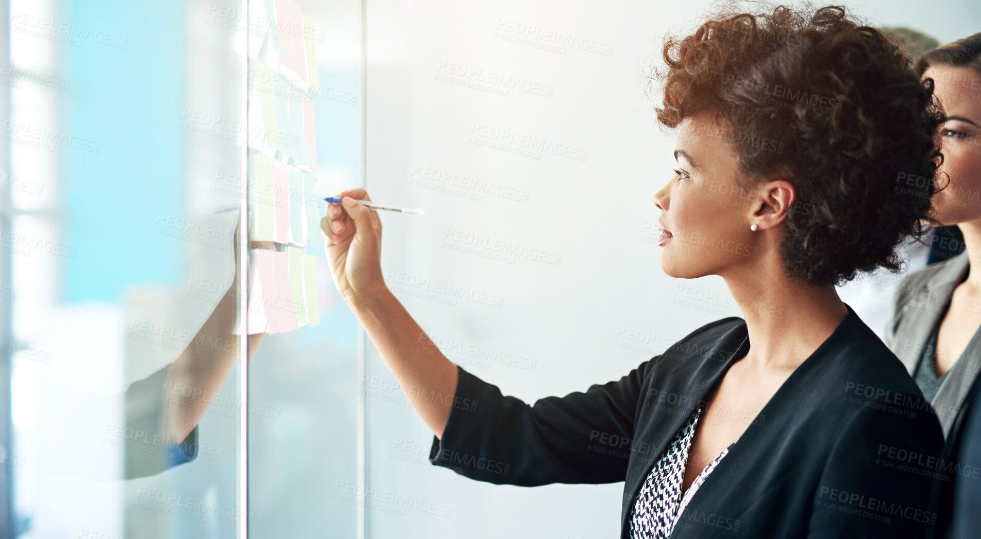 Buy stock photo Shot of colleagues having a brainstorming session at work