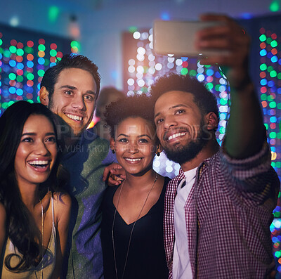 Buy stock photo Cropped shot of a group of friends taking a selfie while partying in a club