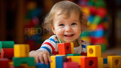 Portrait of a happy toddler playing with building blocks at kindergarten or playroom.