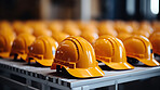 Close-up of yellow hard hat, helmet on factory table. Construction, labour day concept.