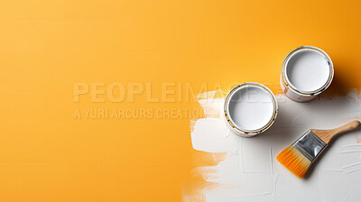 Top view of open paint tins with brush on yellow backdrop.Copy space. DIY renovation concept.