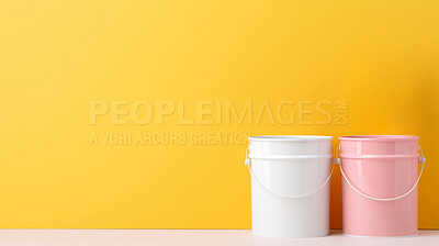 Paint buckets against yellow wall. Copy space. DIY renovation concept.