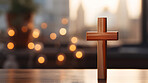 Close up of small wooden cross on table. Copy space. Religion and faith concept.