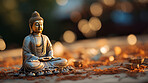 Close-up of bronze colour buddha on table. Copy space. Meditation, religion concept.