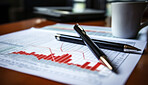 Pen on office table with financial documents. Office background. Stock market concept.