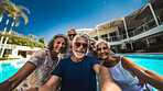 Senior friends in swimming pool. Active holiday fun, fitness and longevity