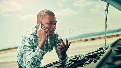 Buy stock photo Cropped shot of a young man calling roadside assistance after breaking down