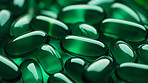 Green gel pills background. Health supplement and science medicine research concept