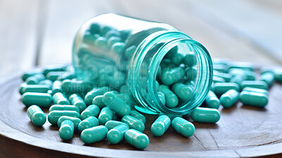 Green pills in glass container. Health supplement and science medicine research concept