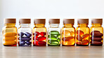 Colorful gel pills in glass containers. Health supplement and science medicine research concept