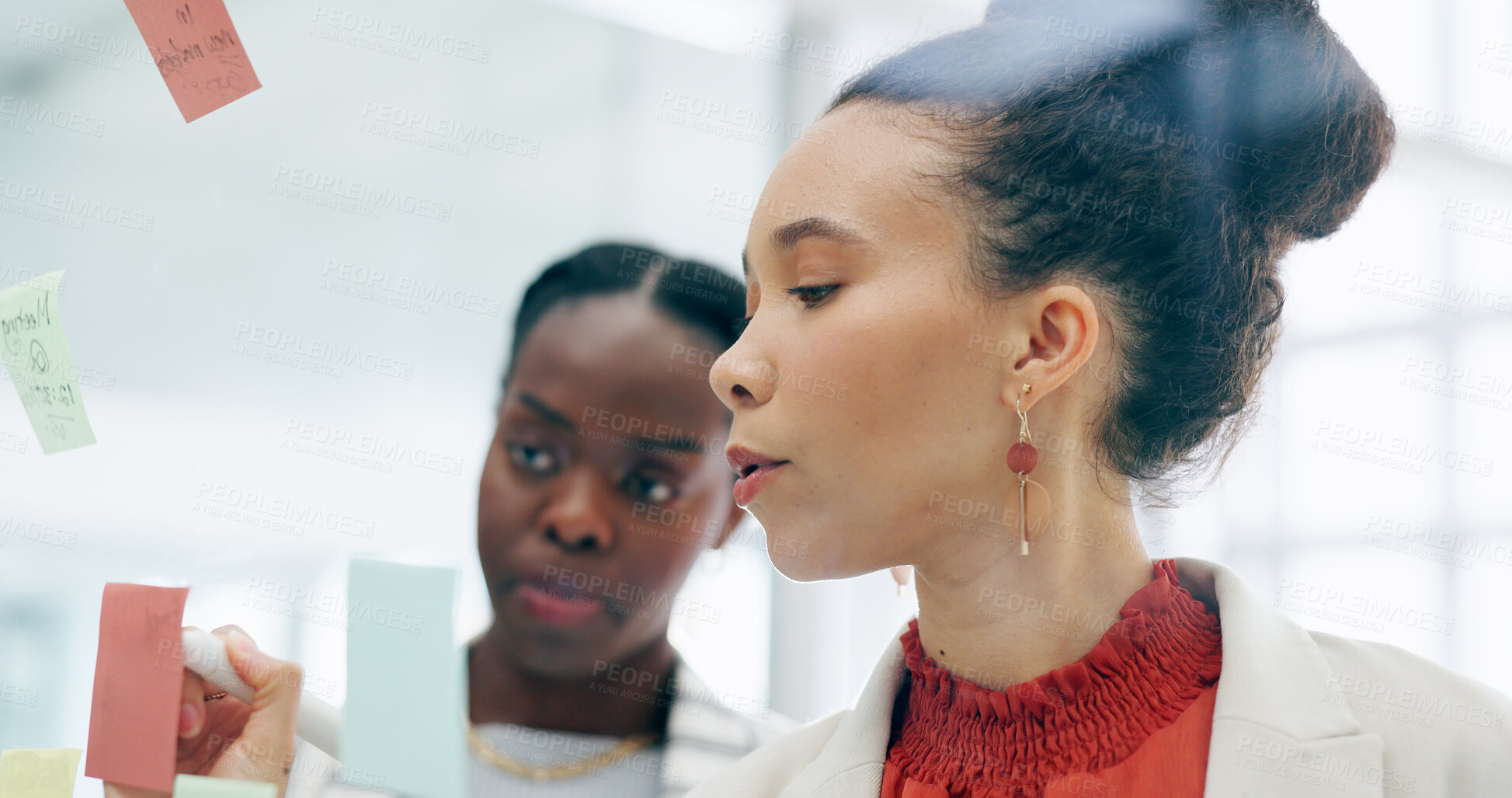 Buy stock photo Sticky note, glass wall and business people writing, collaboration or brainstorming creative strategy, notes or ideas. Problem solving, teamwork and professional women planning advertising project