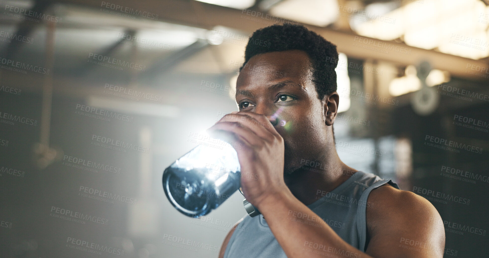 Buy stock photo Black man at gym, water bottle and relax to hydrate in muscle development, strong body and fitness. Commitment, motivation and bodybuilder with drink in workout challenge for health and wellness.