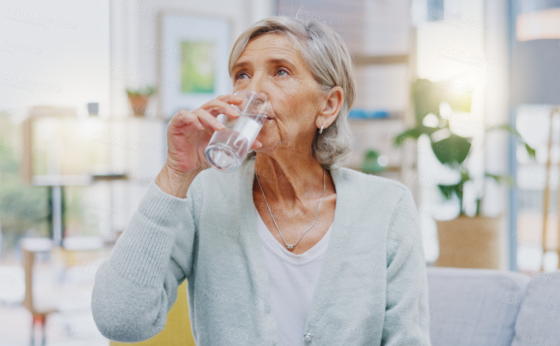 Buy stock photo Wellness, home or healthy old woman drinking water for healthcare or natural vitamins in a house. Retirement, elderly relaxing or thirsty senior person refreshing with liquid for energy or hydration