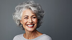 Radiant mature senior model woman with grey hair laughing and smiling for spa and dental