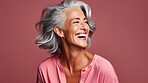 Radiant mature senior model woman with grey hair laughing and smiling for spa and dental