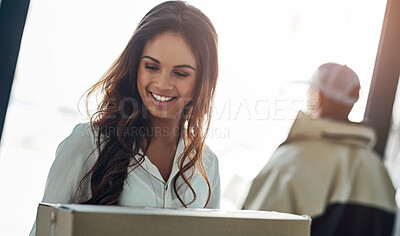 Buy stock photo Cropped shot of a businesswoman holding a package from a courier in her office