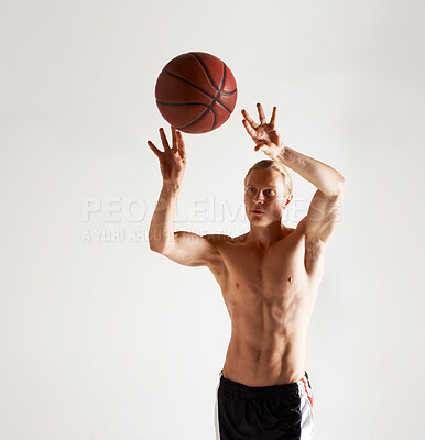 Buy stock photo A handsome young man throwing a basketball