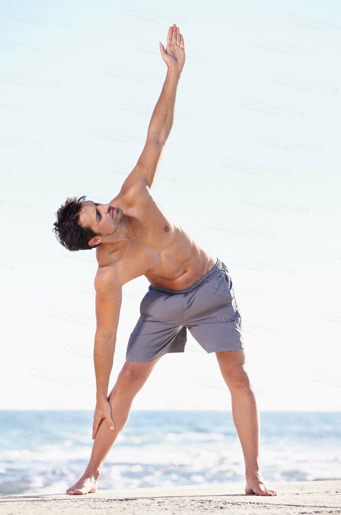 Buy stock photo Fitness, man and stretching body on beach for yoga or getting ready for exercise, workout or training in nature. Fit, active or muscular male yogi in warm up stretch, cardio or exercising by an ocean