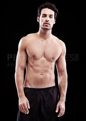Buy stock photo Studio shot of a bare-chested and fit young man with tattoo markings
