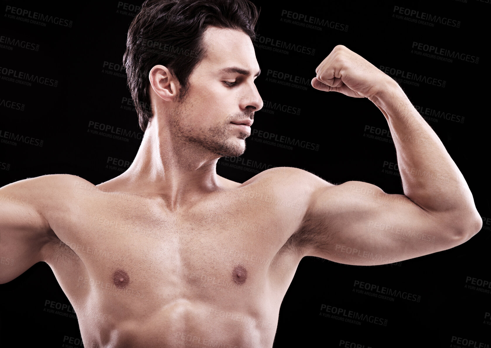 Buy stock photo Studio shot of a handsome bare-chested man flexing a bicep