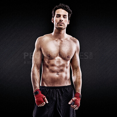 Buy stock photo Studio shot of a confident young boxer isolated on black