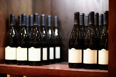 Buy stock photo Shot of some bottles of wine on a shelf in a wine cellar