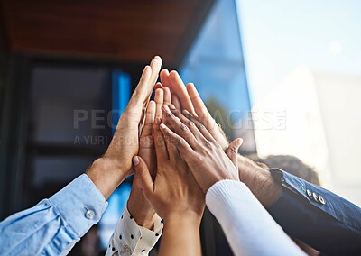 Buy stock photo Cropped shot of a group of unrecognizable colleagues giving each other a high five