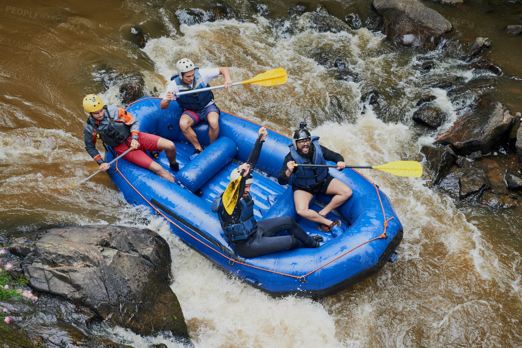 Buy stock photo Shot of a group of young male friends white water rafting
