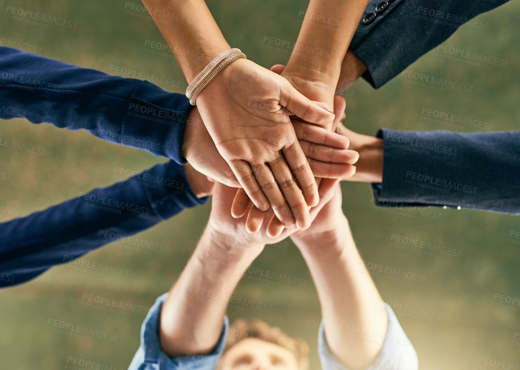 Buy stock photo Closeup shot of a group of people joining their hands in a huddle 