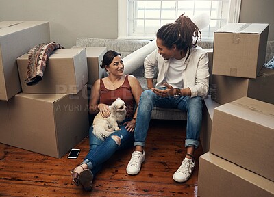 Buy stock photo Shot of a couple sitting with their dog while taking a break on moving day