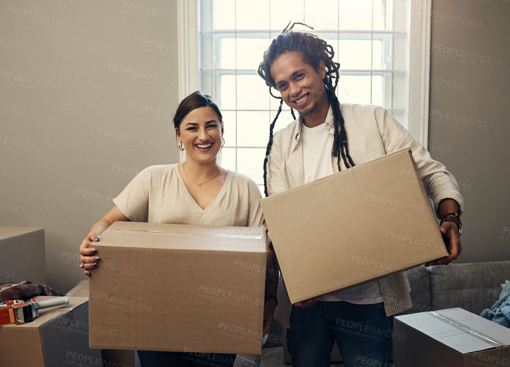 Buy stock photo Shot of a happy young couple moving into their new home