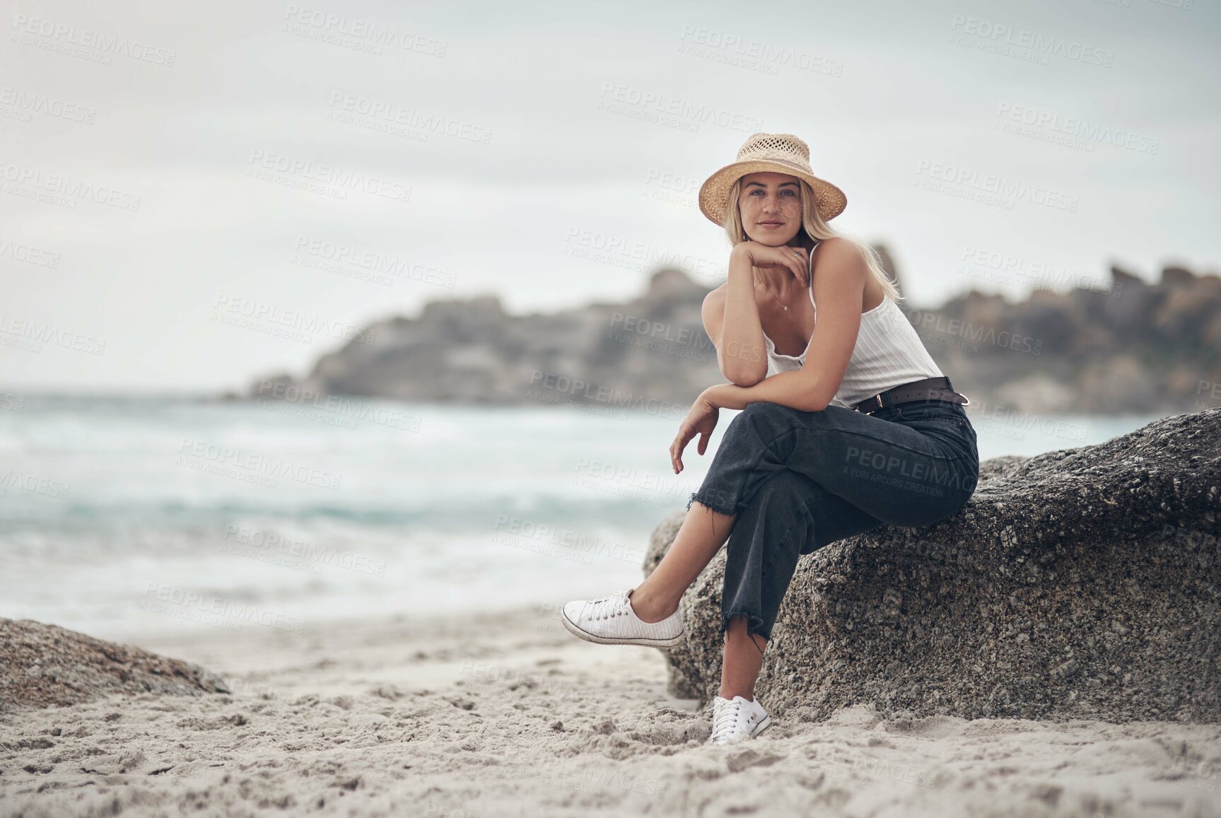 Buy stock photo Shot of a beautiful young woman spending the day at the beach