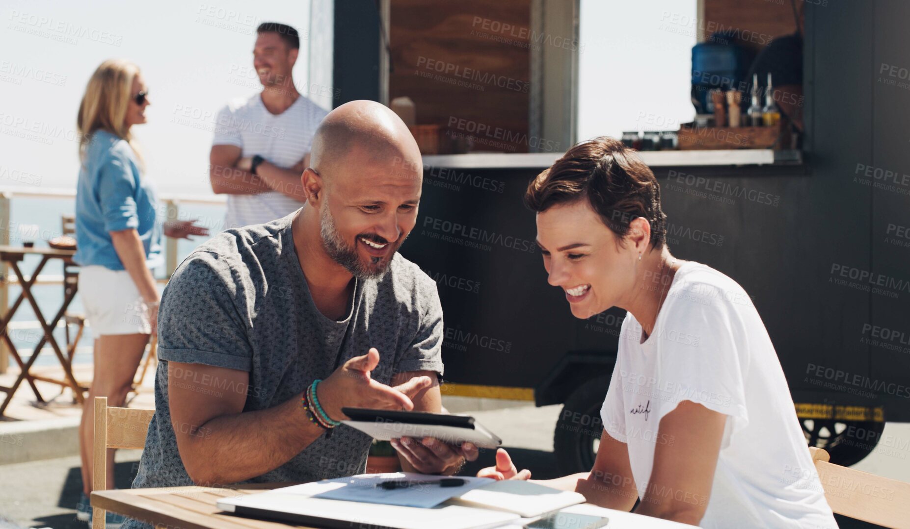 Buy stock photo Shot of a businessman and businesswoman working outside using a digital tablet