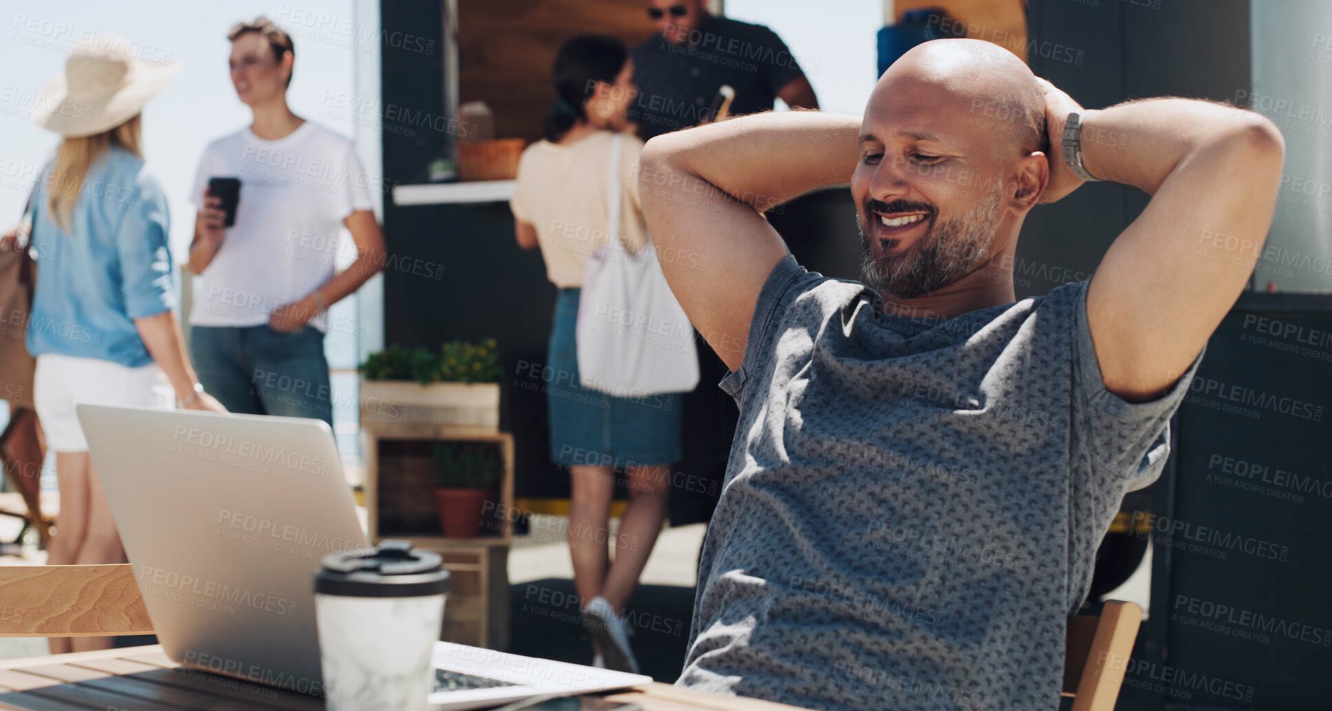 Buy stock photo Shot of a businessman sitting and working at a table outside using his laptop