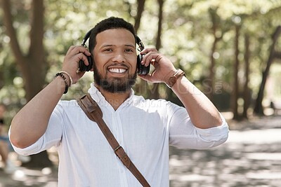 Buy stock photo Happy, portrait and a businessman with music in a park to travel to work in the morning. Smile, young and a male corporate employee listening to a podcast, streaming the radio or audio in nature