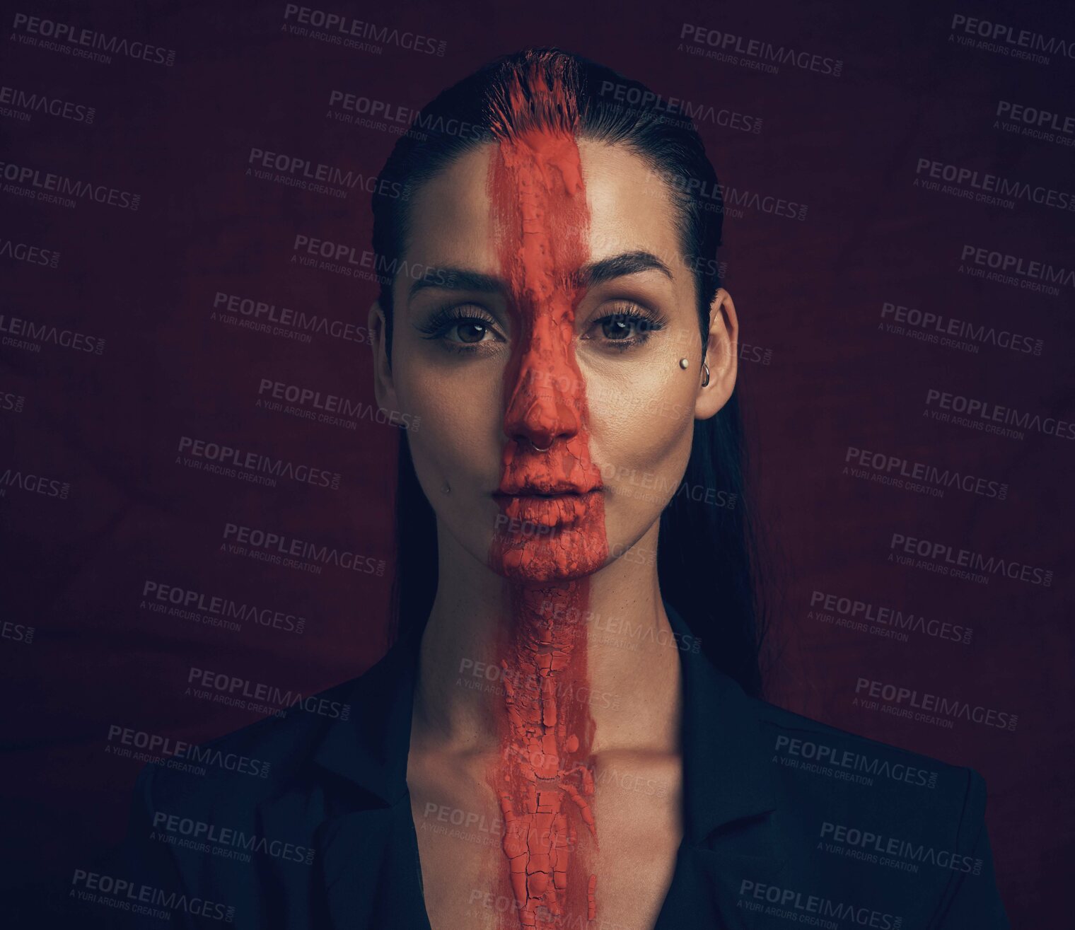 Buy stock photo Studio shot of a young woman posing with paint on her face on a black background