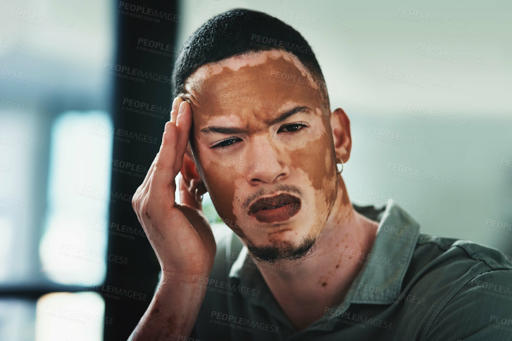 Buy stock photo Shot of a young businessman struggling with a headache in an office at work