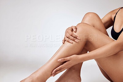 Buy stock photo Closeup cropped studio shot  of a young woman in black underwear modelling her unique tattoos against a grey background