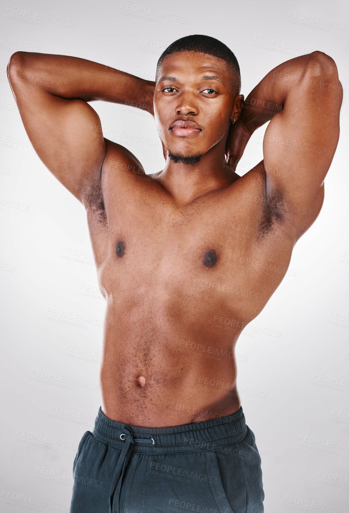 Buy stock photo Studio portrait of a shirtless handsome young man posing against a white background