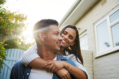 Buy stock photo Cropped shot of an affectionate young couple chilling outside on their patio in the yard