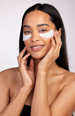 Buy stock photo Happy woman, portrait and eye mask for skincare, collagen or dermatology against a grey studio background. Face of female person or model smiling for beauty cosmetics, patches or facial treatment