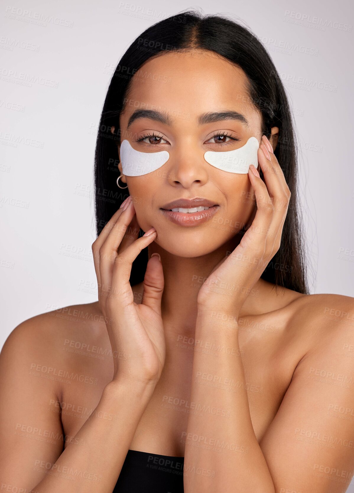 Buy stock photo Studio portrait of an attractive young woman wearing under eye patches against a pink background