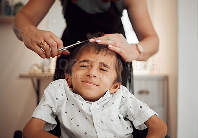 Buy stock photo Child with disability, hair cut and hands of hairdresser trim, groom and salon haircare service to young disabled kid. Barber studio, boy with cerebral palsy at haircut appointment with anxiety