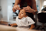 Hairdresser, child with disability and wheelchair with hairstylist cutting his hair at salon. Young kid with cerebral palsy in Mexico getting professional haircut with scissors from beautician woman