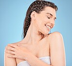 Beauty, skincare and water with woman in shower for cleaning, hygiene and relax. Self care, wellness and cosmetics with girl model for product, facial and hydration in blue background studio