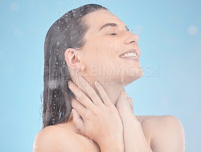 Buy stock photo Beauty, skincare and woman in shower with water drops for hair care, clean body and hygiene smile on blue studio background. Aesthetic model self care, cleaning and routine for health and wellness